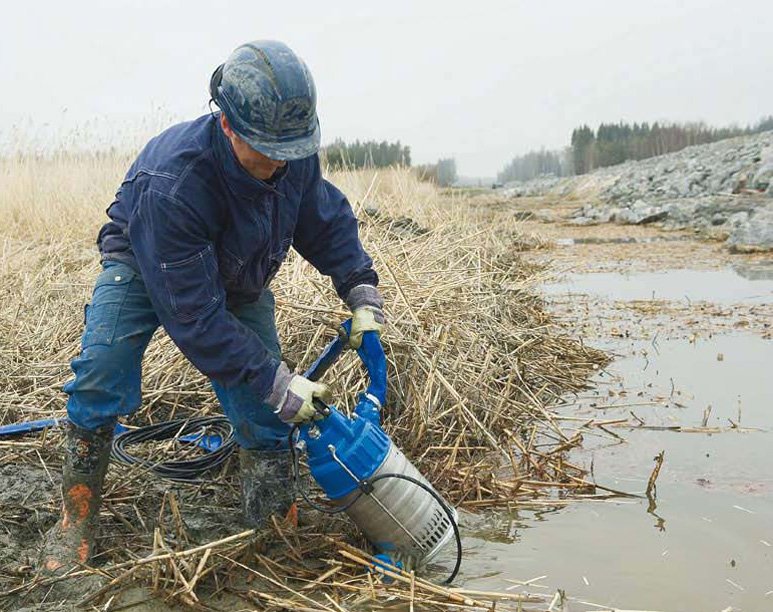 Откачивание воды из канавы при помощи дренажного насоса